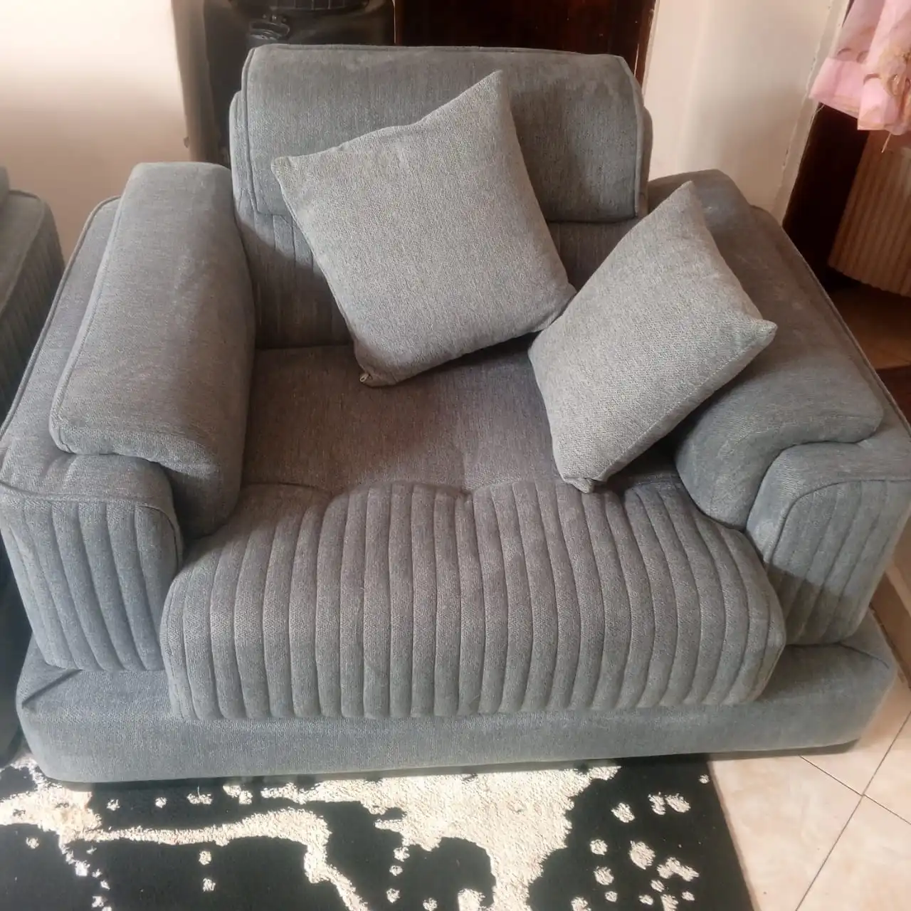 Clean grey armchair with pillows
